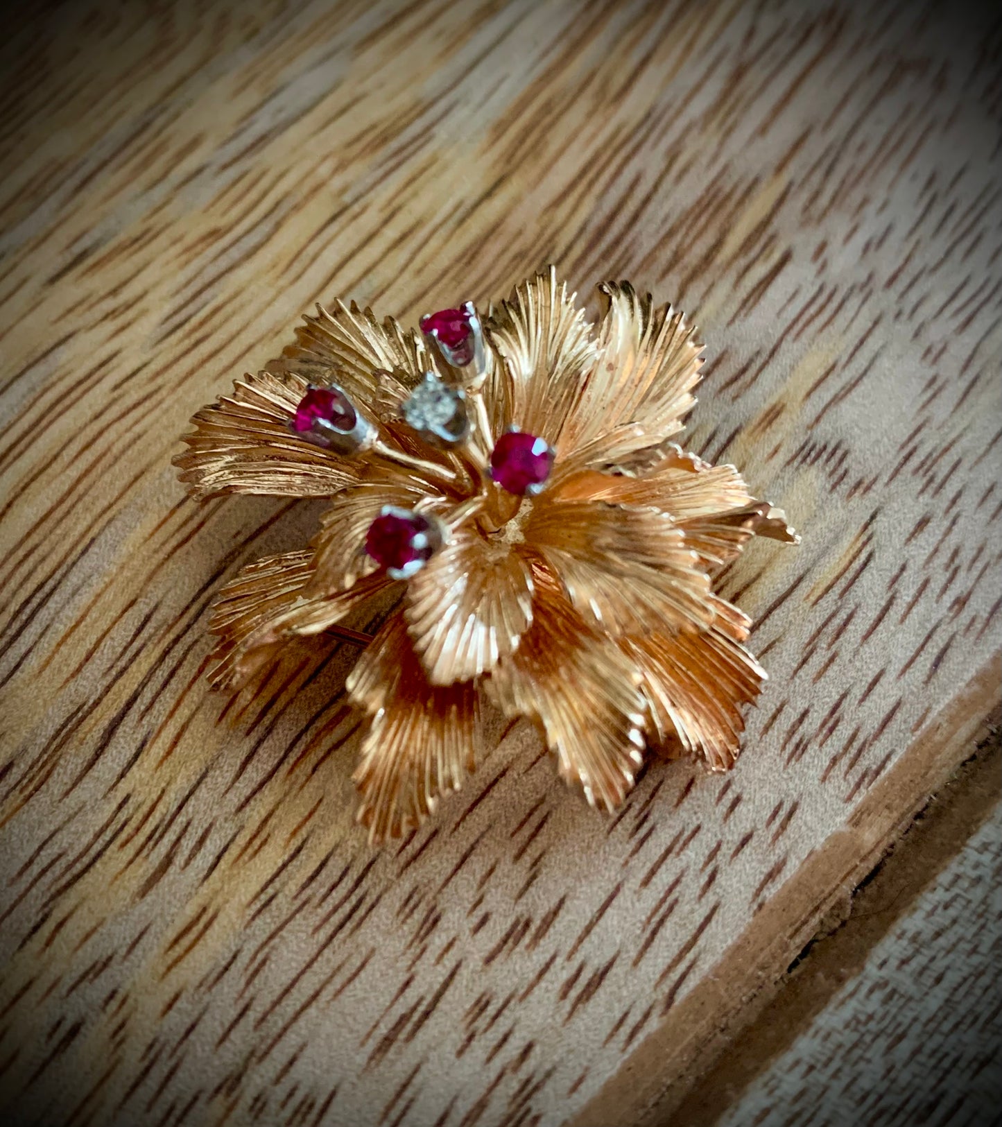 A solid gold, diamond and ruby ring