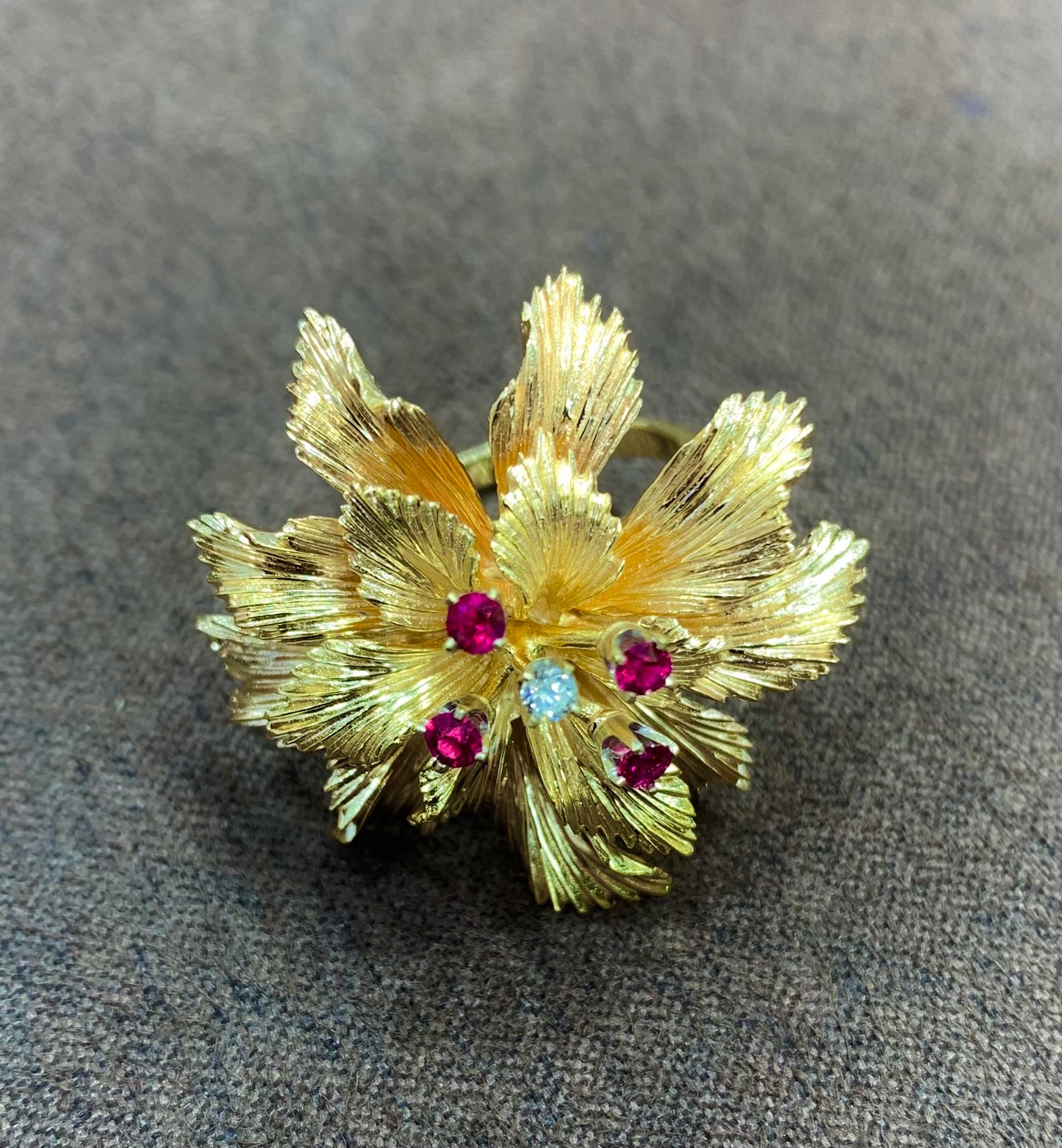 A solid gold, diamond and ruby ring